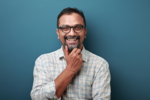 Portrait Of A Smiling Middle Aged Man Of Indian Origin